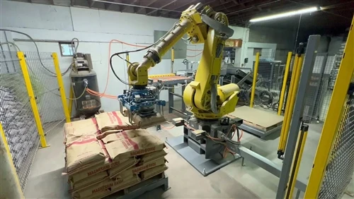 A bag-palletizing robot is grasping a bag. A bag-palletizing robot is grasping a bag.